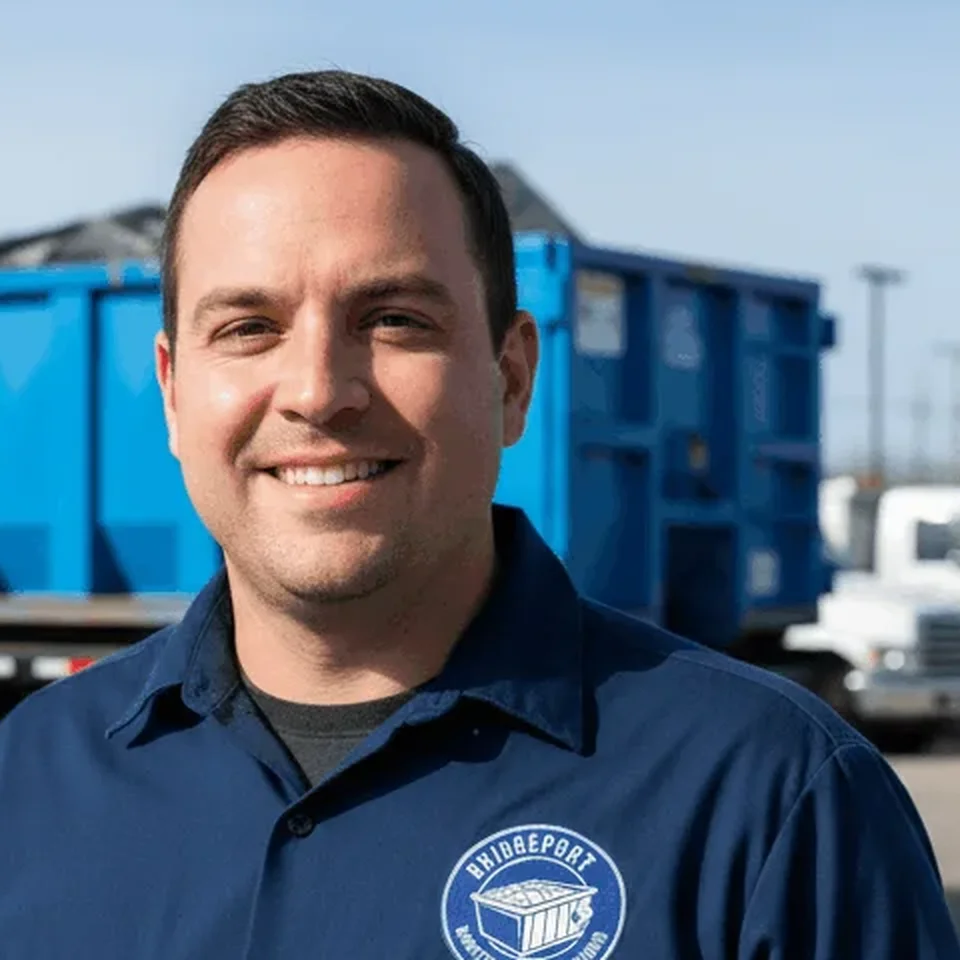 Marcus Bellamy - Driver Marcus Bellamy, Driver at Bridgeport Dumpster Rental Solutions, standing beside a loaded roll-off container